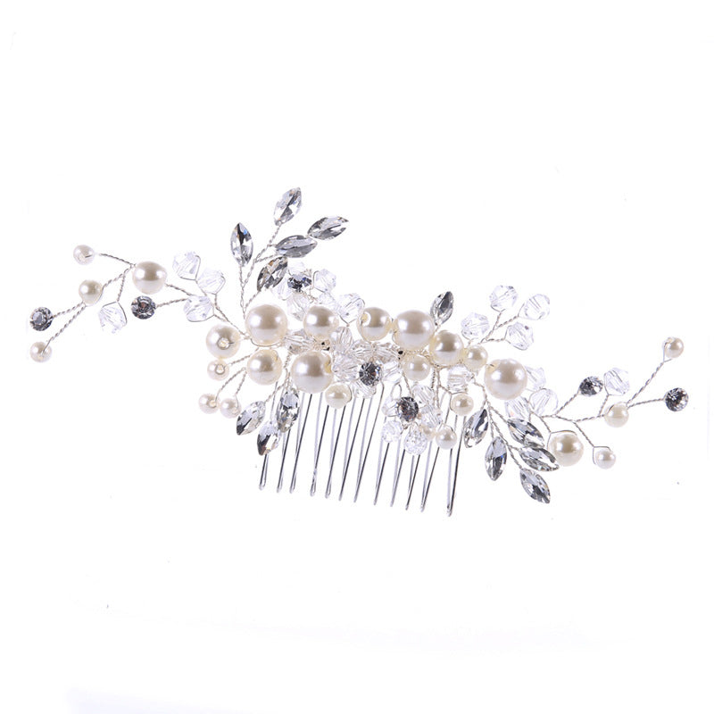 Decorative hair comb with pearls and crystals on a white background
