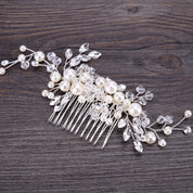 Pearl and crystal hair comb on a wooden surface