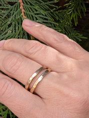 Handmade brass stacking rings worn together on the hand