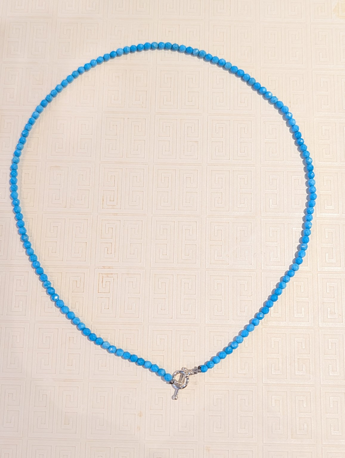 Full view of handmade 4mm turquoise bead necklace with sterling silver toggle clasp