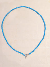 Full view of handmade 4mm turquoise bead necklace with sterling silver toggle clasp
