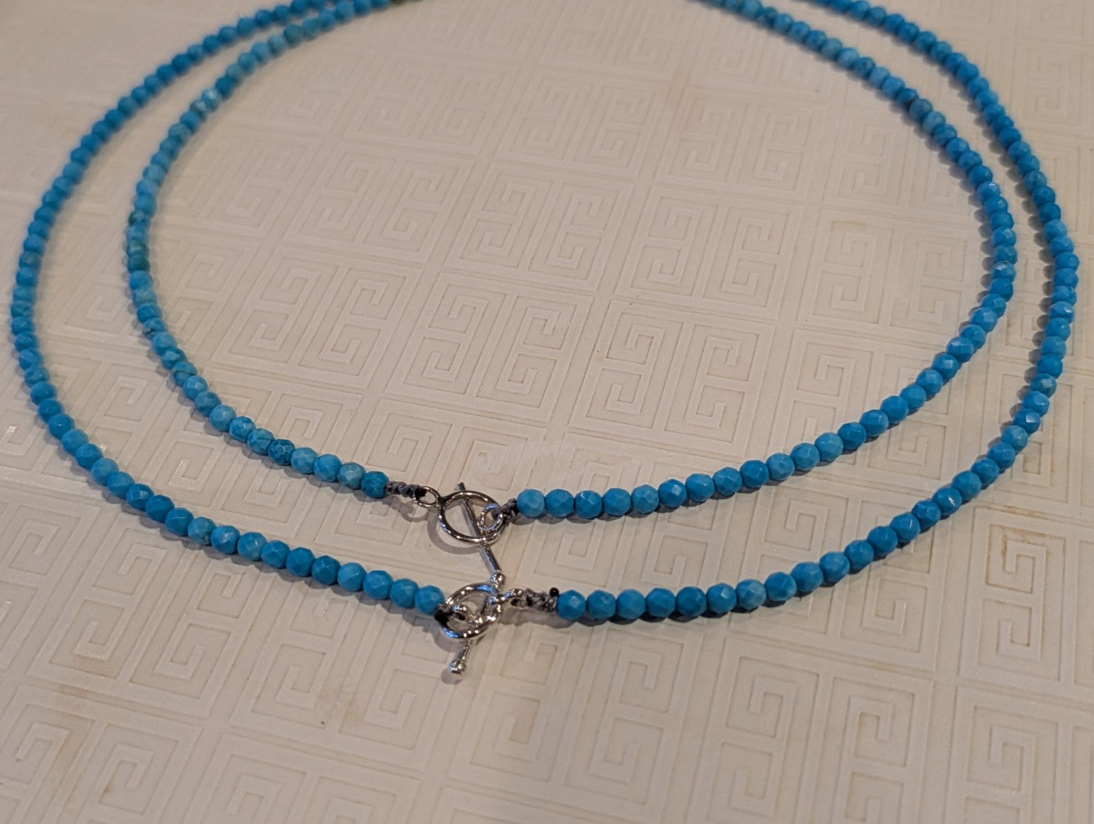 Two handmade turquoise necklaces showing sterling silver toggle clasps